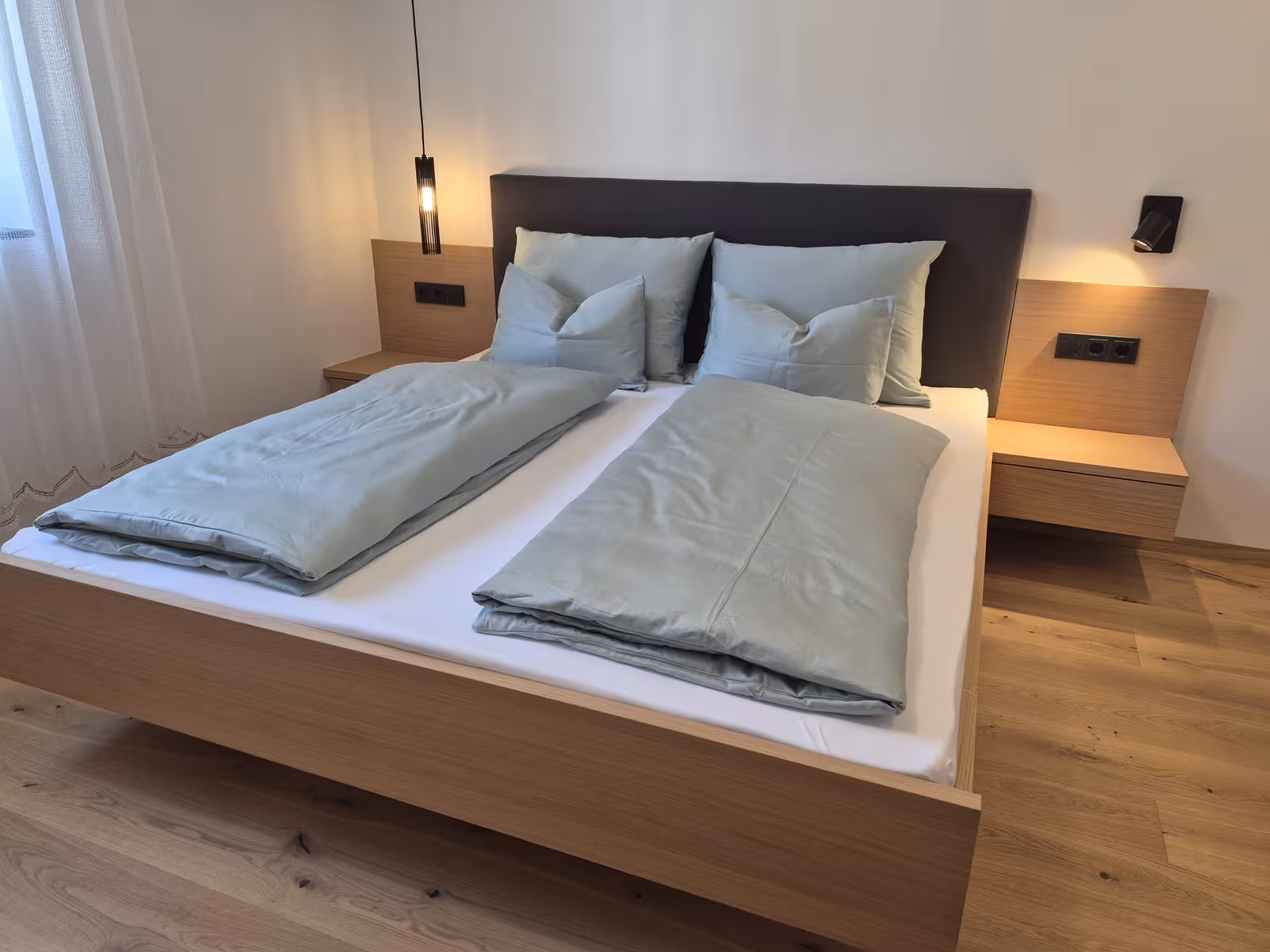 A bright, newly built apartment with warm wooden floors and a terrace that opens onto the garden, for two to four guests.