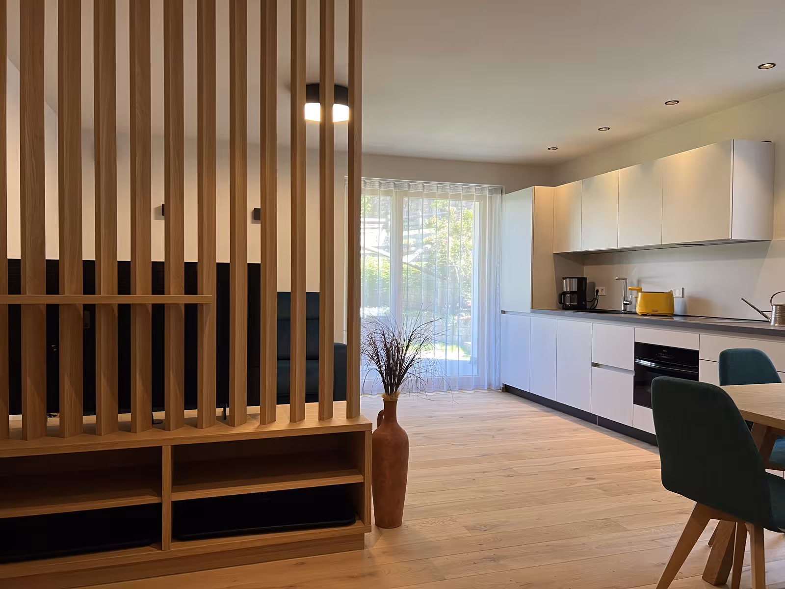 A slightly smaller, newly built apartment with warm wooden floors and a terrace that opens onto the garden, for two to four guests.